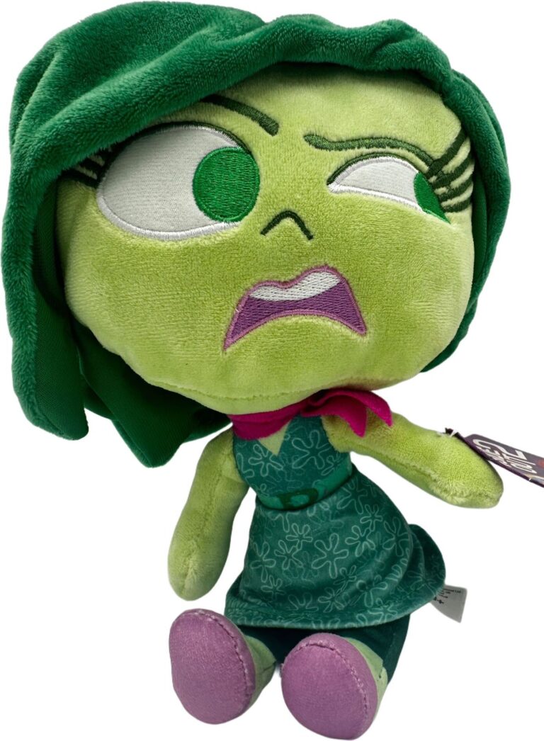 Grüne Plüschfigur mit ausdrucksstarkem Gesicht und lila Schuhen. Grüne Plüschfigur mit ausdrucksstarkem Gesicht und lila Schuhen.